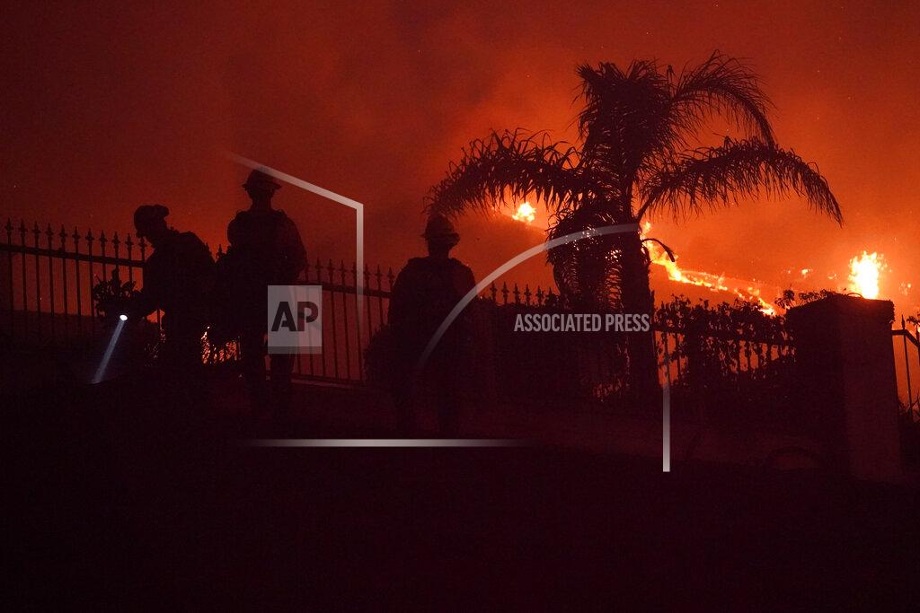 Marcio Jose Sanchez Firefighters work to put out a structure burning during a wildfire Wednesday, May 11, 2022, in Laguna Niguel, Calif. (AP Photo/Marcio Jose Sanchez)