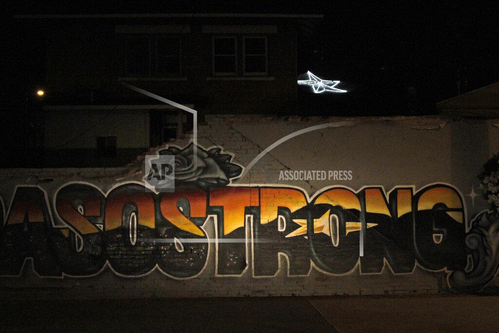 Cedar Attanasio In this May 7, 2020, photo, an "El Paso Strong" mural is seen at night in El Paso, Texas. Gabe Vasquez and Justin Martinez painted the mural in August after the mass shooting at a Walmart on that killed 23 people. The star painted in the mural's letters can be seen in the background on the southern slope of the Franklin Mountains. (AP Photo/Cedar Attanasio)