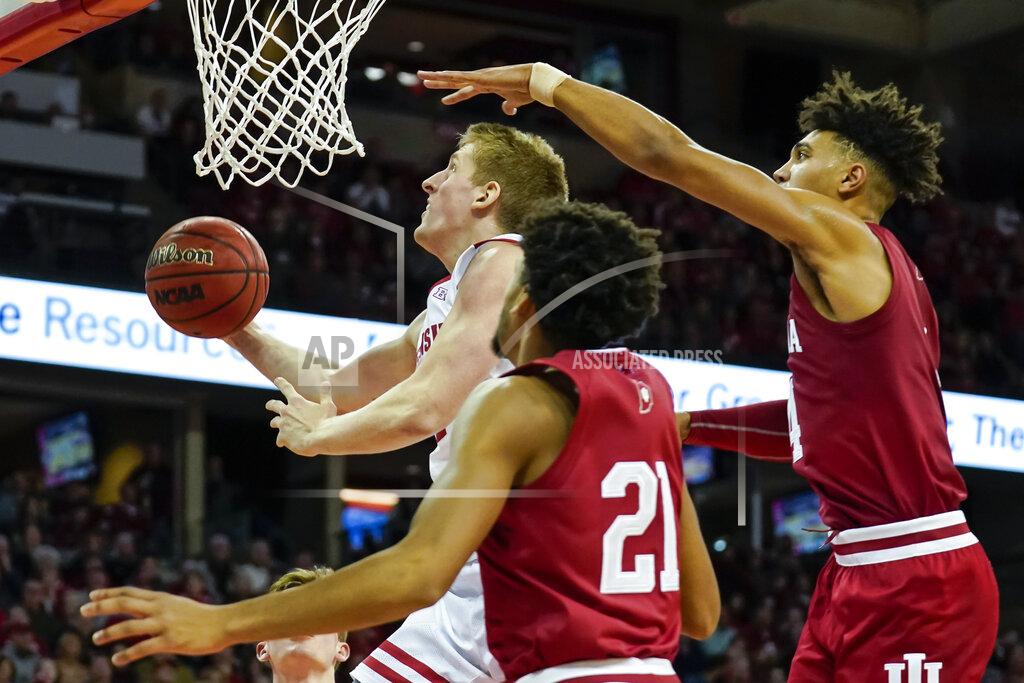 Andy Manis Wisconsin's Brevin Pritzl, left, shoots past Indiana's Jerome Hunter (21) and Aljami Durham, right, during the second half of an NCAA college basketball game Saturday, Dec. 7, 2019, in Madison, Wis. Wisconsin won 84-64. (AP Photo/Andy Manis)