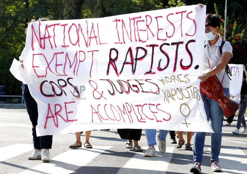 Philippos Christou Protesters hold a banner in support of a British woman who is appealing her conviction for making false claims that she was gang raped by as many as a dozen Israelis, in front of Cyprus' Supreme Court in the capital Nicosia on Thursday, Sept. 16, 2021. Lawyers for the British woman sentenced to a four-month suspended sentence for making up the gang rape claims during a 2019 Cyprus holiday are appealing to the country's Supreme Court to overturn the conviction. (AP Photo/Philippos Christou)