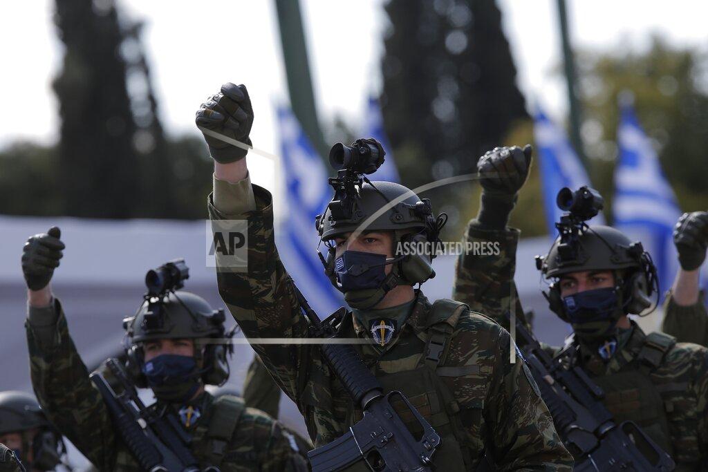 Kostas Tsironis Members of the Greek special forces march during an army parade in Athens, Thursday, March 25, 2021. Fighter jets flew by the ancient Acropolis and tanks rumbled past parliament in central Athens as Greece's celebrations for the bicentenary of the nation's war of independence culminated in a military parade attended by dignitaries from Britain, France and Russia but no public.(Kostas Tsironis/Pool via AP)
