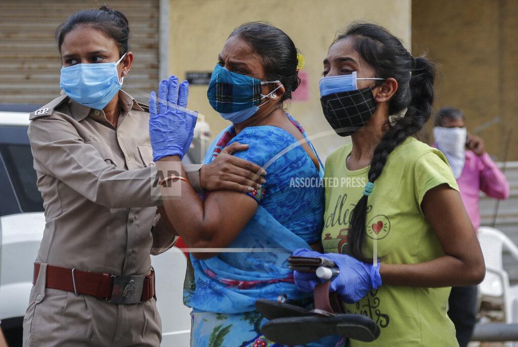 Ajit Solanki Relatives of a patient who died of COVID-19, mourn outside a government COVID-19 hospital in Ahmedabad, India, Tuesday, April 27, 2021. The COVID-19 death toll in India has topped 200,000 as the country endures its darkest chapter of the pandemic yet. (AP Photo/Ajit Solanki)