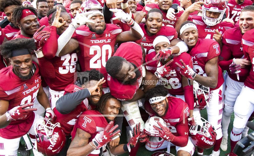 Chris Szagola Temple players celebrate following their 24-17 win in overtime against Cincinnati in an NCAA college football against Cincinnati, Saturday, Oct. 20, 2018, in Philadelphia. (AP Photo/Chris Szagola)