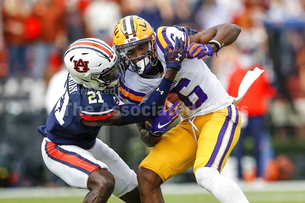 LSU wide receiver Terrace Marshall Jr. (6) is tacked by Auburn defensive back Smoke Monday (21) after a reception during the first quarter of an NCAA college football game on Saturday, Oct. 31, 2020, in Auburn, Ala. (AP Photo/Butch Dill)