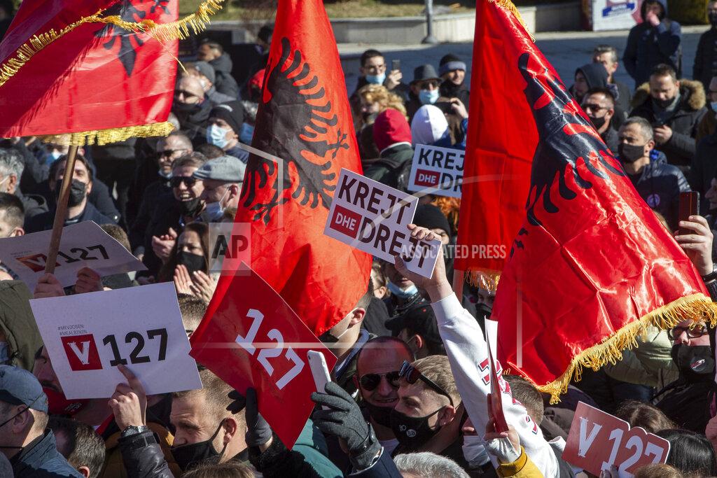 Visar Kryeziu Supporter of VETEVENDOSJE (Self-Determination) political party holds a slogan reading in Albanian " All and Straight" during the closing electoral rally in capital Pristina on Friday, Feb. 12, 2021. Kosovo holds an early general election upcoming Sunday and the next government will face challenges including pandemic economic recovery, reducing unemployment and fighting organized crime.(AP Photo/Visar Kryeziu)