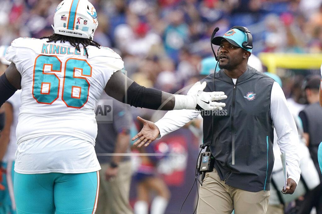 Steven Senne Miami Dolphins head coach Brian Flores, right, congratulates offensive guard Solomon Kindley (66) during the first half of an NFL football game against the New England Patriots, Sunday, Sept. 12, 2021, in Foxborough, Mass. (AP Photo/Steven Senne)