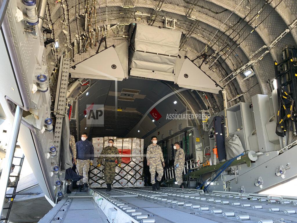 Uncredited In this handout photo provided by the Turkish Defense Ministry, Turkish soldiers prepare to load a military cargo plane with Personal Protection Equipment donated by Turkey to help United States combat the new coronavirus outbreak, at the Etimesgut airport outside Ankara, Turkey, Tuesday, April 28, 2020. Turkey is sending a planeload of surgical masks, N95 masks and hazmat suits to U.S. to help the country battle the coronavirus outbreak.(Turkish Defence Ministry via AP)
