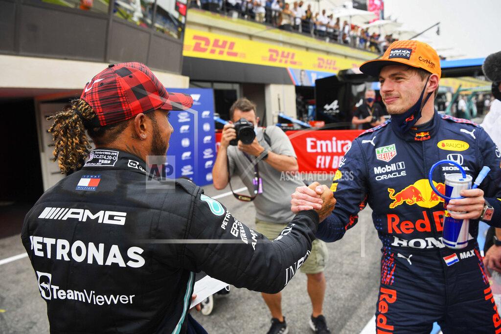 Nicolas Tucat Red Bull driver Max Verstappen of the Netherlands, right, shakes hands with Mercedes driver Lewis Hamilton of Britain after he clocked the fastest time during the qualifying session ahead of the French Formula One Grand Prix at the Paul Ricard racetrack in Le Castellet, southern France, Saturday, June 19, 2021. The French Grand Prix will be held on Sunday. (Nicolas Tucat/Pool via AP)