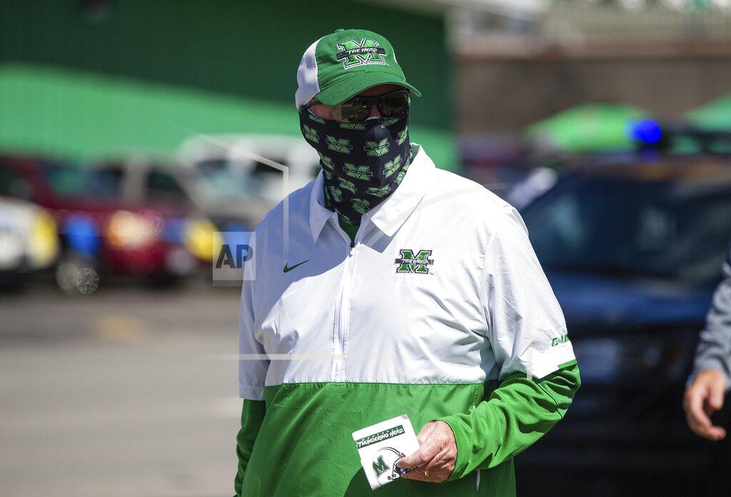Sholten Singer Marshall head coach Doc Holliday leads in the team as they arrive for their game against Appalachian State before an NCAA college football game Saturday, Sept. 19, 2020, in Huntington, W.Va. (Sholten Singer/The Herald-Dispatch via AP)
