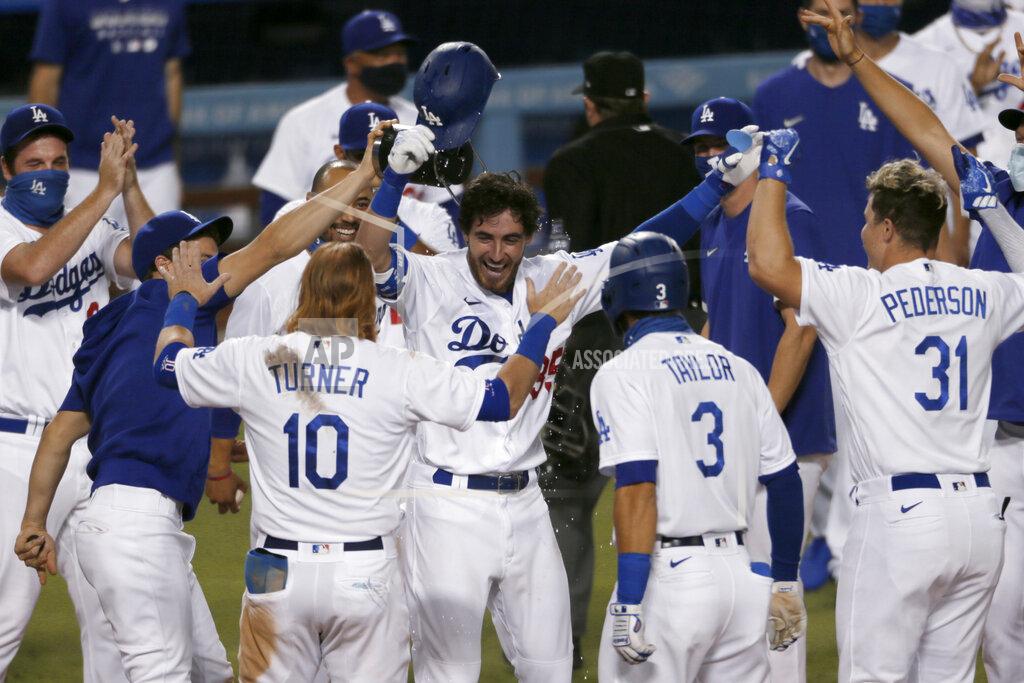 Alex Gallardo Los Angeles Dodgers' Cody Bellinger, center, is welcomed by teammates after his game-ending solo home run during the ninth inning of a baseball game against the Colorado Rockies in Los Angeles, Saturday, Aug. 22, 2020. (AP Photo/Alex Gallardo)