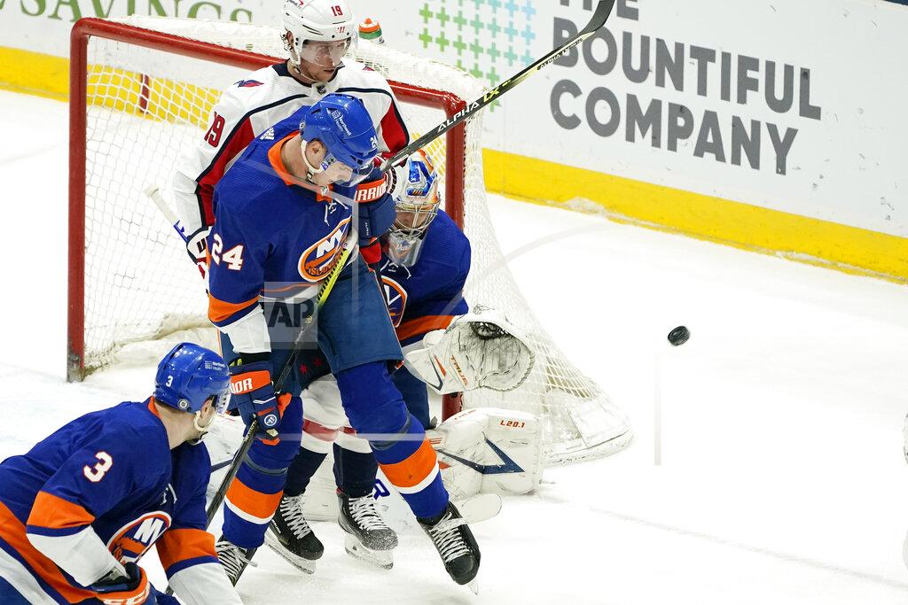 Kathy Willens New York Islanders' Scott Mayfield (24) defends against Washington Capitals center Nicklas Backstrom (19) as Islanders goaltender Semyon Varlamov (40) makes a save during the second period of an NHL hockey game Thursday, April 22, 2021, in Uniondale, N.Y. (AP Photo/Kathy Willens)