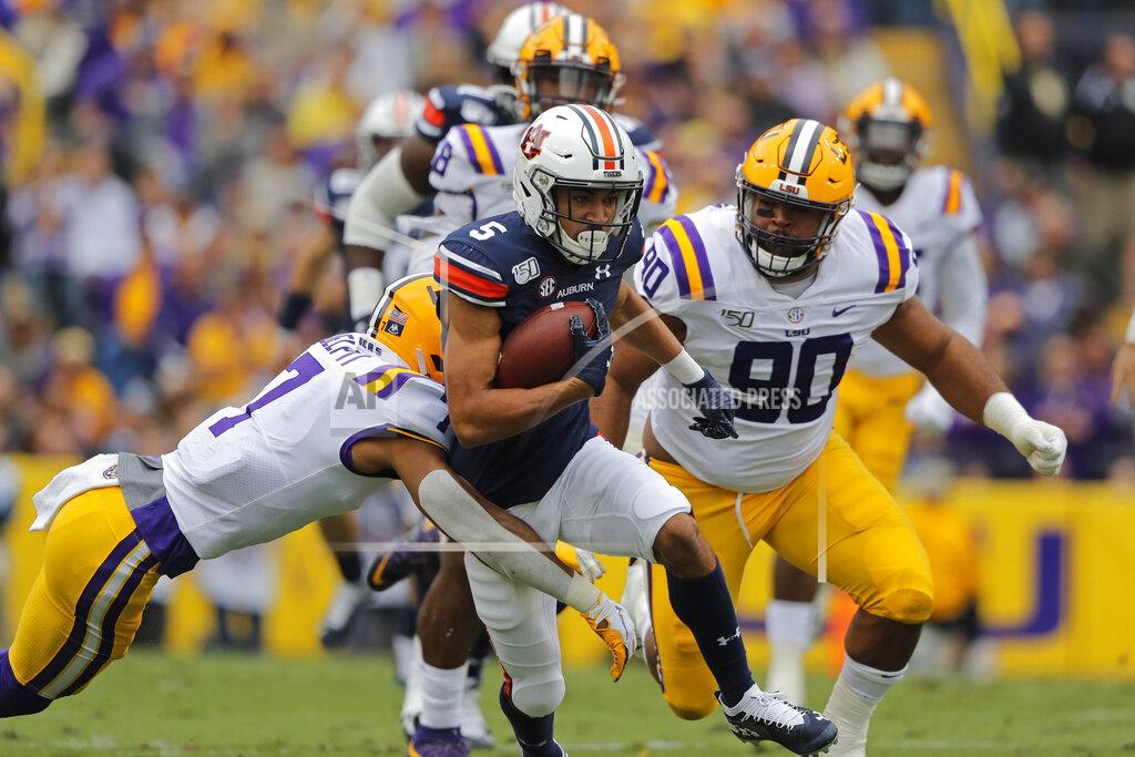 Gerald Herbert Auburn wide receiver Anthony Schwartz (5) carries against LSU safety Grant Delpit (7) in the first half of an NCAA college football game in Baton Rouge, La., Saturday, Oct. 26, 2019. (AP Photo/Gerald Herbert)