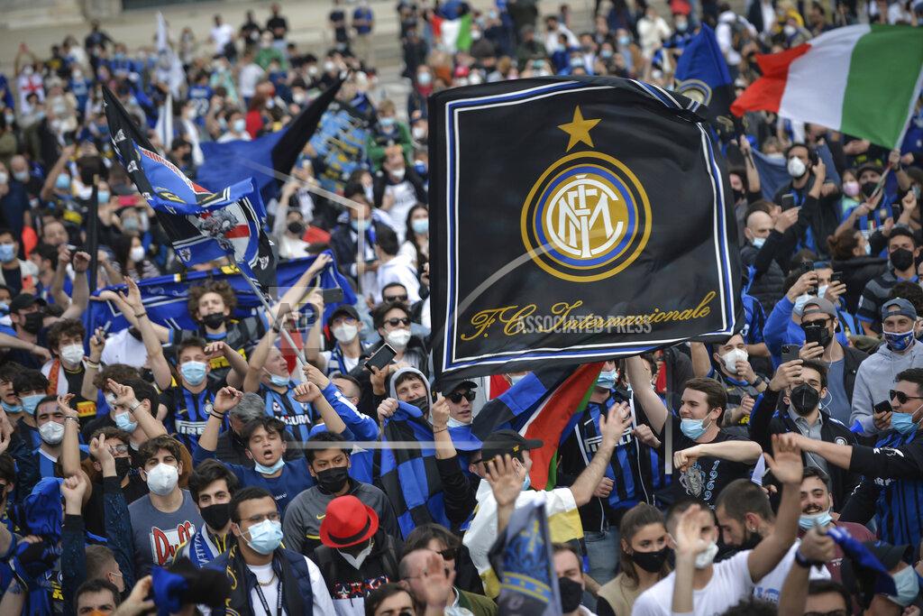 Claudio Furlan Inter Milan fans celebrate with flares and shout slogans in Piazza Duomo square in front of the gothic cathedral after Inter Milan won its first Serie A title in more than a decade after second-placed Atalanta drew 1-1 at Sassuolo, in Milan, Italy, Sunday, May 2, 2021. Atalanta needed to win to avoid Inter mathematically clinching the title with four matches remaining. It was Inter’s first trophy since 2011 and the first Serie A title since 2010. (Claudio Furlan/LaPresse via AP)