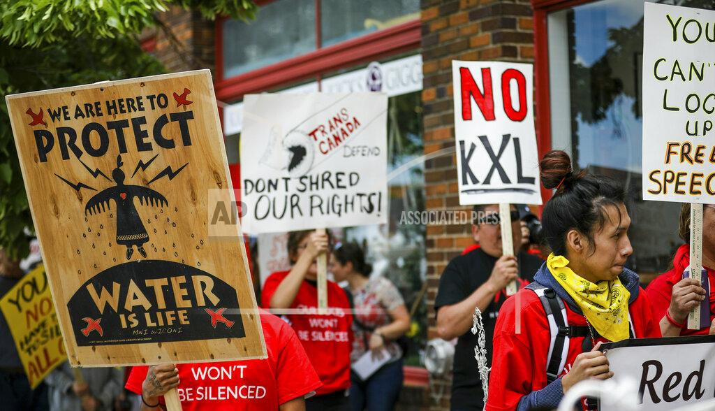 FILE - In this June 12, 2019, file photo, protesters walk up Main Street inasa procession protesting against the Keystone XL pipeline makes its way to Andrew W. Bogue Federal Courthouse in Rapid City, S.D. A U.S. Supreme Court decision this week could further stall construction of the disputed pipeline just as work began this spring after years of delay. (Adam Fondren/Rapid City Journal via AP, File)