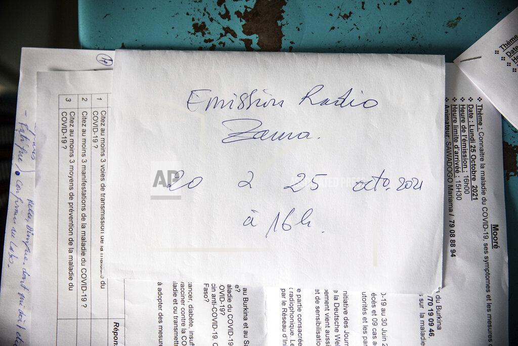 Sophie Garcia Mariama Sawadogo's show scripts on COVID-19 are set out on a table at Zama Radio, in Kaya, Burkina Faso, Monday, Oct. 25, 2021. Many guests and listeners in Burkina Faso call her "aunty" as she gently guides them to the right answers and awards prizes such as soap and washing buckets. In the West African country of Burkina Faso, many feel the government has let them down during the pandemic. Tests, vaccines and messaging often miss many residents, despite a $200 million budget for virus-response efforts. In a region where women are responsible for family work and community relationships, they’ve stepped up to fill in gaps. (AP Photo/Sophie Garcia)