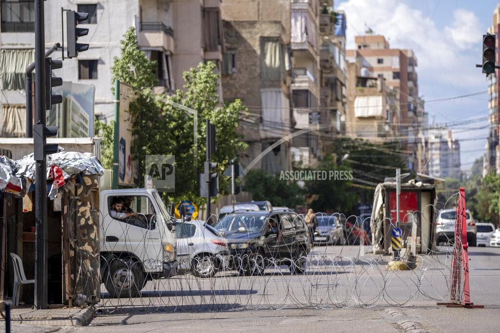 Hassan Ammar Lebanese army blocks a road by barbed wire that leads to the Ain el-Rumaneh neighborhood after the deadly clashes that erupted last Thursday along a former 1975-90 civil war front-line between Muslim Shiite and Christian areas, in Beirut, Lebanon, Tuesday, Oct. 19, 2021. The shootout on the streets of Beirut between rival Christian and Muslim groups has revived memories of the country's 1975-90 civil war and fired up sectarian passions in a country that never dealt with the causes of its violent past. (AP Photo/Hassan Ammar)