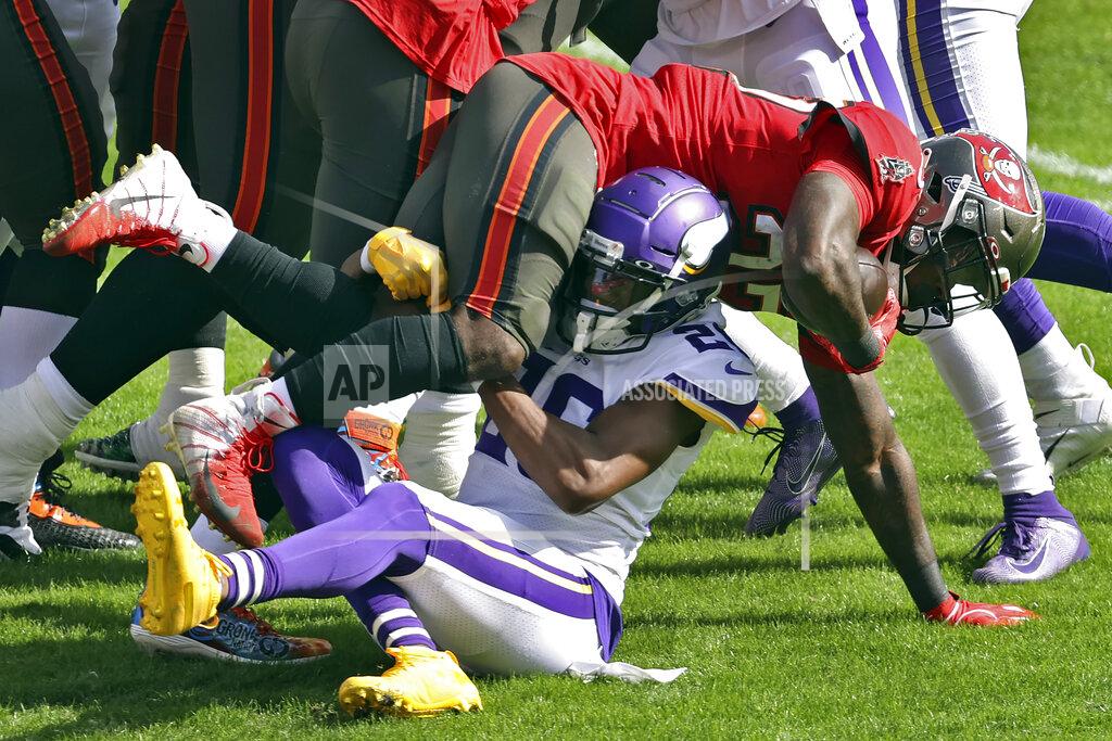 Mark Lomoglio Minnesota Vikings defensive back Chris Jones (26) upends Tampa Bay Buccaneers running back Ronald Jones II (27) during the first half of an NFL football game Sunday, Dec. 13, 2020, in Tampa, Fla. (AP Photo/Mark LoMoglio)