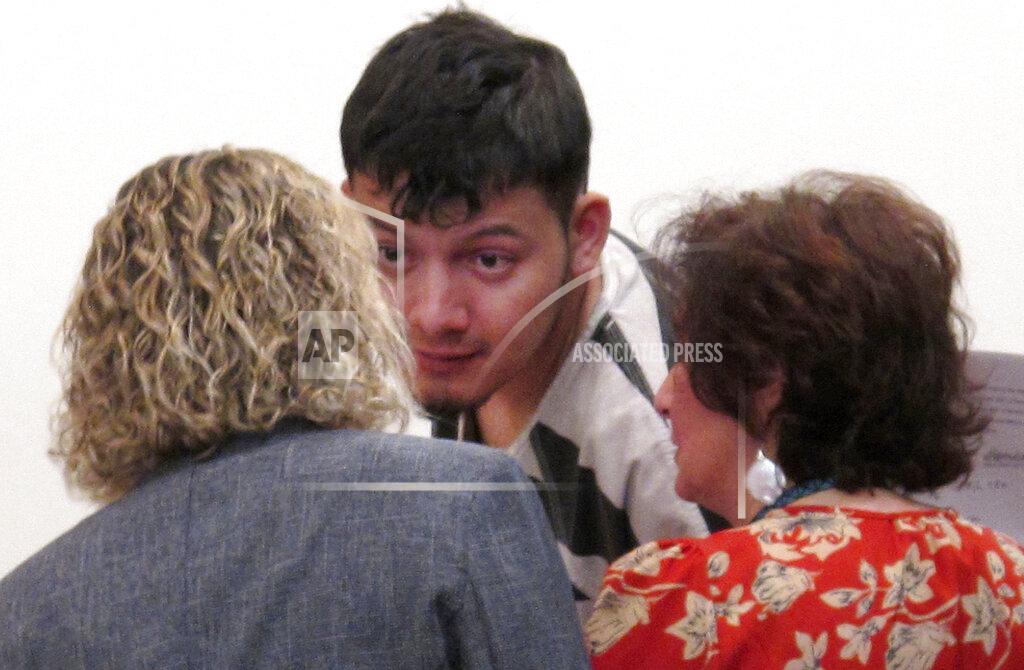 Scott Sonner FILE - In this Thursday, Jan. 24, 2019, file photo Wilber Ernesto Martinez-Guzman, of El Salvador, listens to his public defender and interpreter during his initial appearance in Carson City Justice Court, in Carson City, Nev. The Nevada Supreme Court struck down a deadline Friday, April 9, 2021, that a district judge set later this month for the Salvadoran immigrant's lawyers to file a motion claiming he's intellectually disabled and therefore can't be executed if convicted of murdering a Reno couple and two other woman. (AP Photo/Scott Sonner, File)