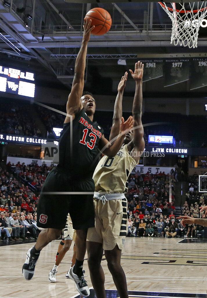 Chuck Burton North Carolina State's C.J. Bryce (13) drives against Wake Forest's Brandon Childress (0) during the first half of an NCAA college basketball game in Winston-Salem, N.C., Tuesday, Jan. 15, 2019. (AP Photo/Chuck Burton)