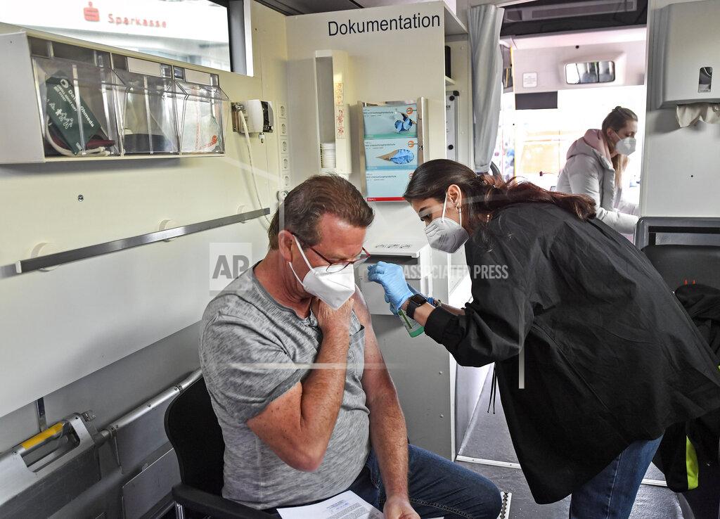Martin Meissner Harald Fischer gets a Moderna vaccination in a vaccination mobile on a square at the district Chorweiler in Cologne, Germany, Monday, May 3, 2021. The city of Cologne started a program to bring COVID-19 vaccination to people living in this neighborhood with a high corona incidence. (AP Photo/Martin Meissner)