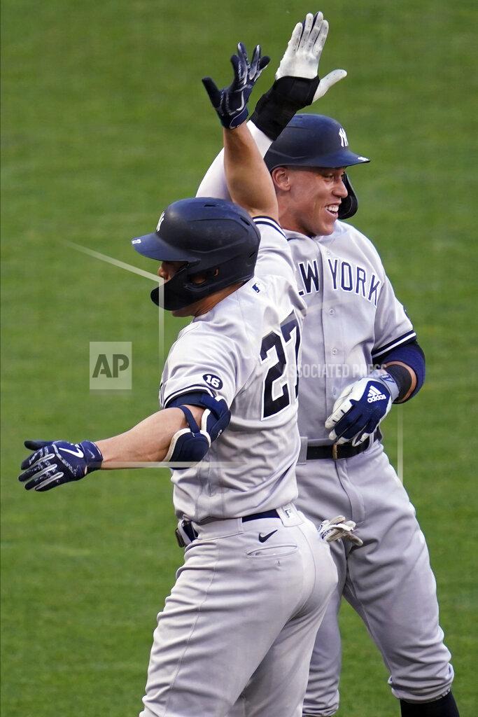 Jim Mone New York Yankees' Giancarlo Stanton (27) and Aaron Judge celebrate Stanton's three-run home run off Minnesota Twins' pitcher J.A. Happ during the first inning of a baseball game Thursday, June 10, 2021, in Minneapolis. (AP Photo/Jim Mone)