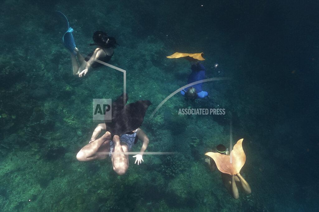 Aaron Favila Queen Pangke Tabora, right, conducts a mermaiding class in Mabini, Batangas province, Philippines on Saturday, May 21, 2022. Across the world, people are increasingly embracing the subculture of “mermaiding.” (AP Photo/Aaron Favila)