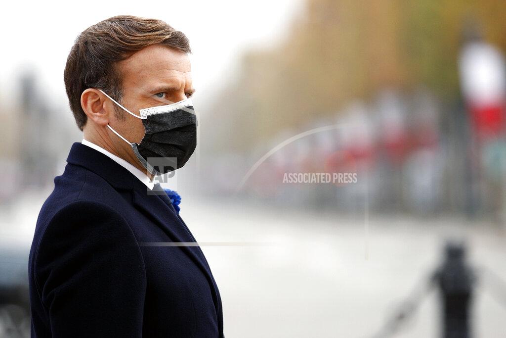 Yoan Valat French President Emmanuel Macron attends Armistice Day ceremonies marking the end of World War I, in Paris, Wednesday, Nov. 11, 2020. French President Emmanuel Macron is commemorating the 102nd anniversary of the armistice ending World War I and honoring all those who have died for France in two elaborate, solemn ceremonies Wednesday. (Yoan Valat/Pool via AP)