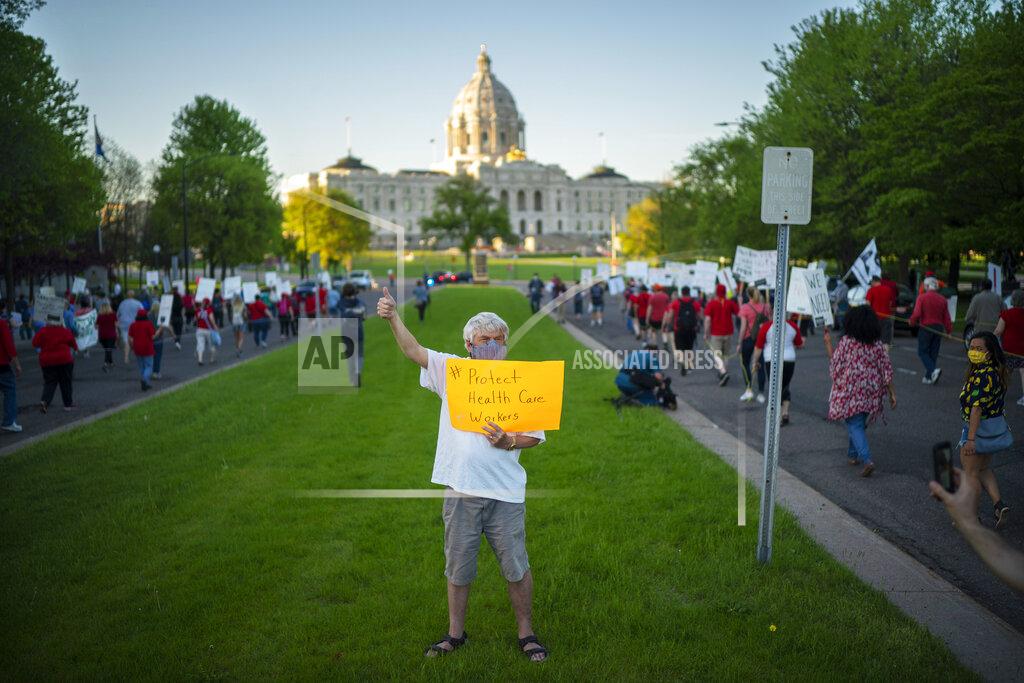 Jeff Wheeler Nurses and supporters march from United Hospital to the State Capitol for a rally, Wednesday, May 20, 2020, in St. Paul, Minn. Nurses are asking for a say in worker protections, increased PPE resources with higher safety standards and an end to retaliation against workers who have tried to protect themselves from the coronavirus. (Jeff Wheeler/Star Tribune via AP)
