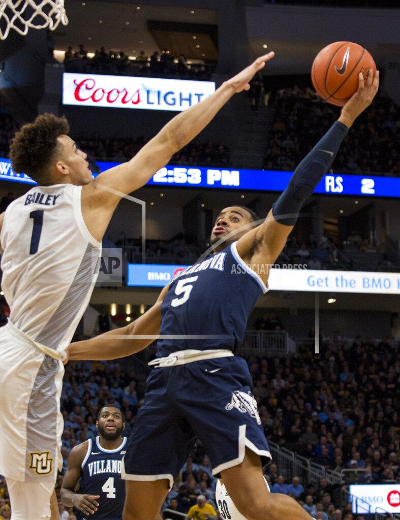 Darren Hauck Villanova guard Phil Booth, right, goes up for a basket against Marquette forward Brendan Bailey, left, during the second half of an NCAA college basketball game Saturday, Feb. 9, 2019, in Milwaukee. Marquette defeated Villanova 66-65. (AP Photo/Darren Hauck)