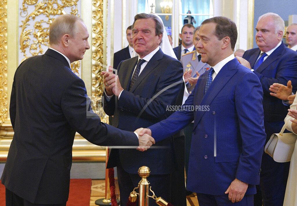 Alexei Druzhinin FILE - Vladimir Putin shakes hands with Dmitry Medvedev during his inauguration ceremony as new Russia's president in the Grand Kremlin Palace in Moscow, Russia, on May 7, 2018, with former German Chancellor Gerhard Schroeder in centre. Gerhard Schroeder left the German chancellery after a narrow election defeat in 2005 with an ambitious overhaul of the country’s welfare state beginning to kick in and every chance of becoming a respected elder statesman. Fast-forward to last week: German lawmakers agreed to shut down Schroeder’s taxpayer-funded office, the European Parliament called for him to be sanctioned, and his own party set a mid-June hearing on applications to have him expelled. Schroeder’s association with the Russian energy sector turned the 78-year-old into a political pariah in Germany after the invasion of Ukraine. (Alexei Druzhinin, Sputnik, Kremlin Pool Photo via AP)