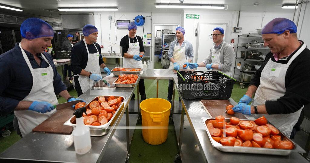 Frank Augstein Volunteers from the charity 'The Felix Project' prepare meals in the kitchen of their hub in London, Wednesday, May 4, 2022. Across Britain, food banks and community food hubs that helped struggling families, older people and the homeless during the pandemic are now seeing soaring demand. The cost of food and fuel in the U.K. has risen sharply since late last year, with inflation reaching the highest level in 40 years. (AP Photo/Frank Augstein)