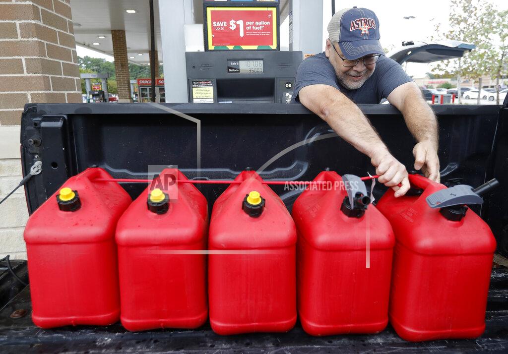 Jason Fochtman Paul Villagomez secures filled gas containers in his truck as he prepares for Tropical Storm Nicholas, Monday, Sept. 13, 2021, in Kingwood, Texas. "I'm just trying to be prepared," Villagomez said. "I'm actually surprised there aren't more people filling up." (Jason Fochtman/Houston Chronicle via AP)