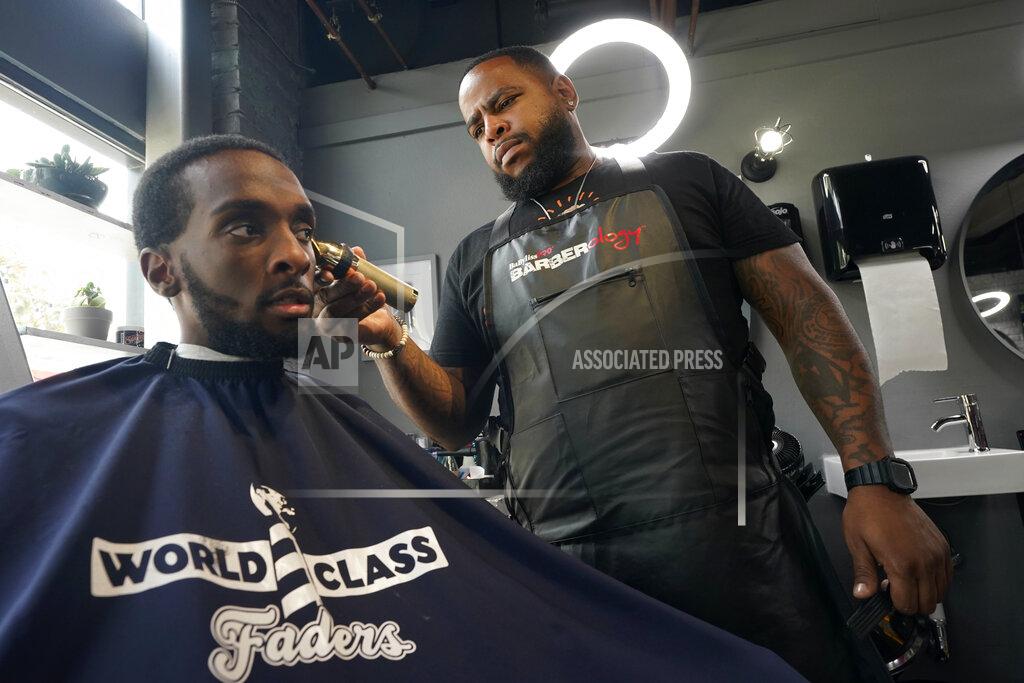 Rich Pedroncelli Barber Dwayne Speed gives a haircut to Artis White at World Class Faders (Barbershop) in Sacramento, Calif., Wednesday, July 28, 2021. Speed is a registered Democrat who says he is unsure how he'll vote in the Sept. 14 recall election against Democratic Gov. Gavin Newsom. (AP Photo/Rich Pedroncelli))