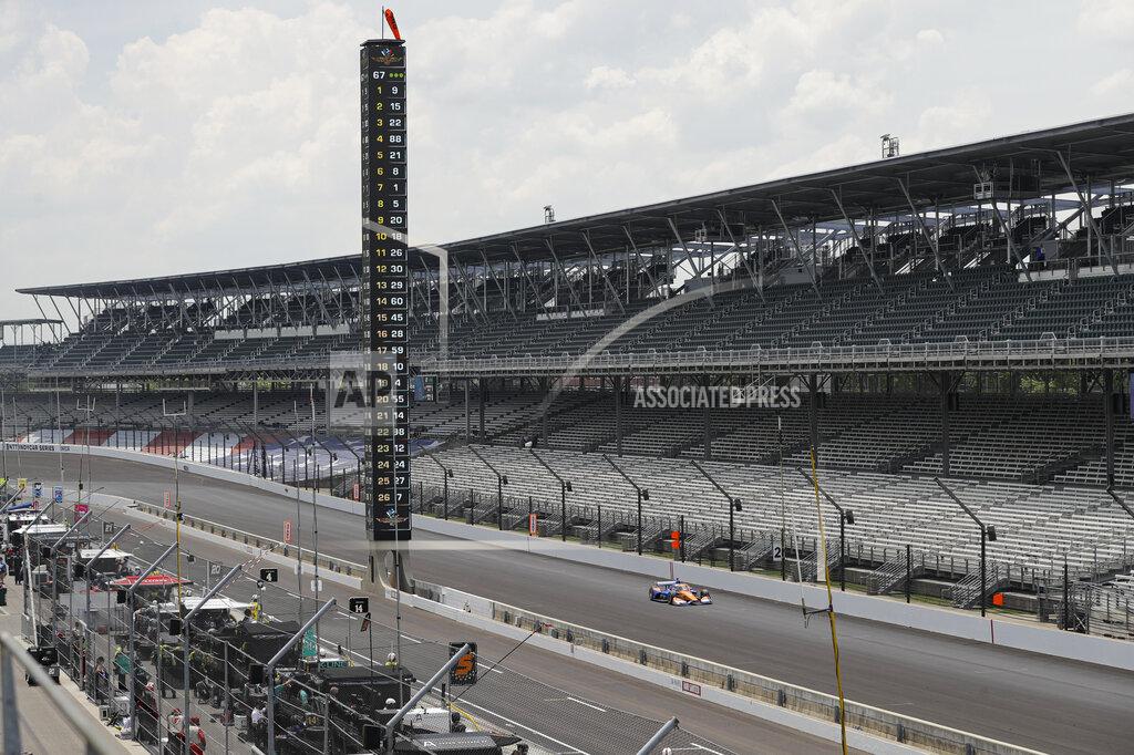 Darron Cummings Race driver Scott Dixon, of New Zealand, drives down the main straight in front of empty stands during the IndyCar auto race at Indianapolis Motor Speedway in Indianapolis, Saturday, July 4, 2020. No fans where allowed due to the coronavirus pandemic. (AP Photo/Darron Cummings)