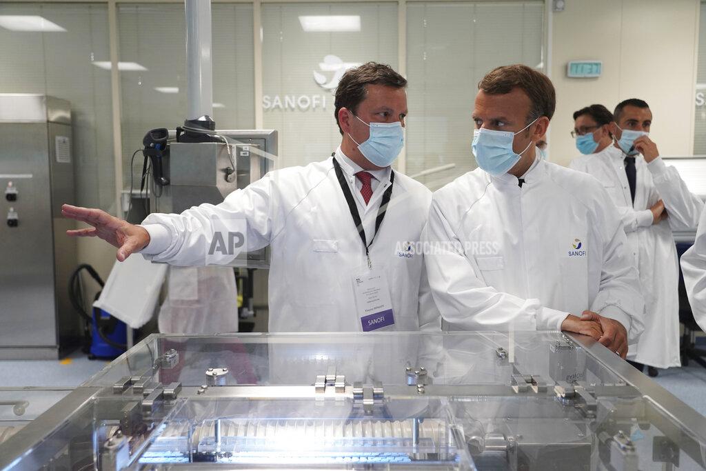 Laurent Cipriani FILE - In this June 16, 2020, file photo, French President Emmanuel Macron listens to researchers as he visits an industrial development laboratory at French drugmaker's vaccine unit Sanofi Pasteur plant in Marcy-l'Etoile, near Lyon, central France, Tuesday. As the race for a vaccine against the new coronavirus intensifies, many rich countries are rushing to the front of the line by placing advance orders for the inevitably limited supply to guarantee their citizens are immunized first. (AP Photo/Laurent Cipriani, Pool, File)