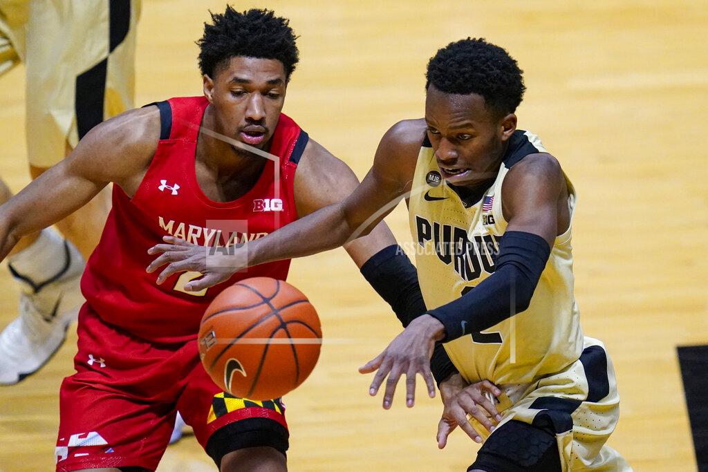 Michael Conroy Purdue guard Eric Hunter Jr., right, loses the ball as he drives past Maryland guard Aaron Wiggins (2) during the second half of an NCAA college basketball game in West Lafayette, Ind., Friday, Dec. 25, 2020. (AP Photo/Michael Conroy)