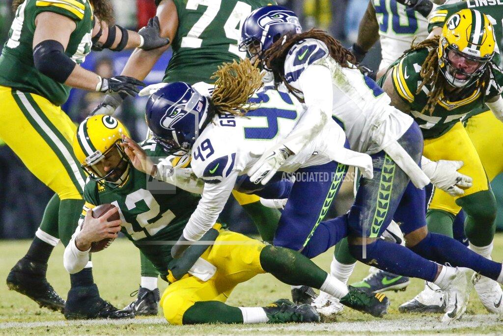 Mike Roemer Seattle Seahawks' Shaquem Griffin and Shaquill Griffin sack Green Bay Packers quarterback Aaron Rodgers during the second half of an NFL divisional playoff football game Sunday, Jan. 12, 2020, in Green Bay, Wis. (AP Photo/Mike Roemer)