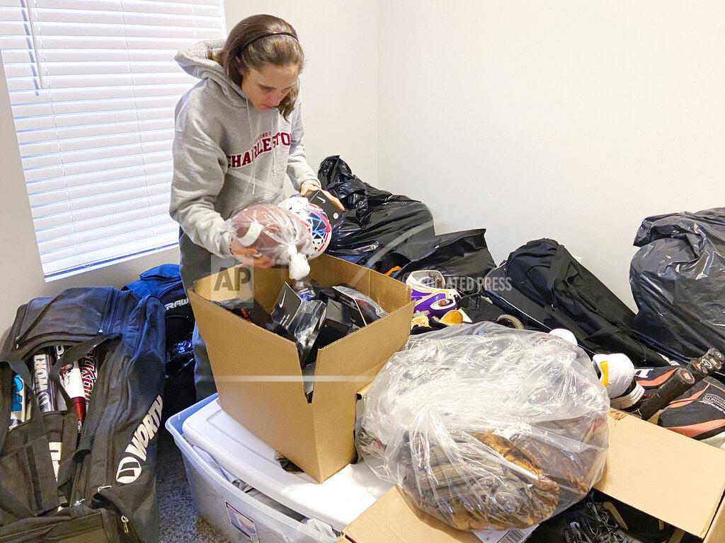 Teresa Walker Rhiannon Potkey sorts sports equipment Jan. 30, 2021, in Knoxville, Tenn. Goods4Greatness, the nonprofit started by Potkey, works to get much-needed gear to low-income children and teens to make sure the high cost of equipment doesn't stop their athletic dreams. (AP Photo/Teresa Walker)