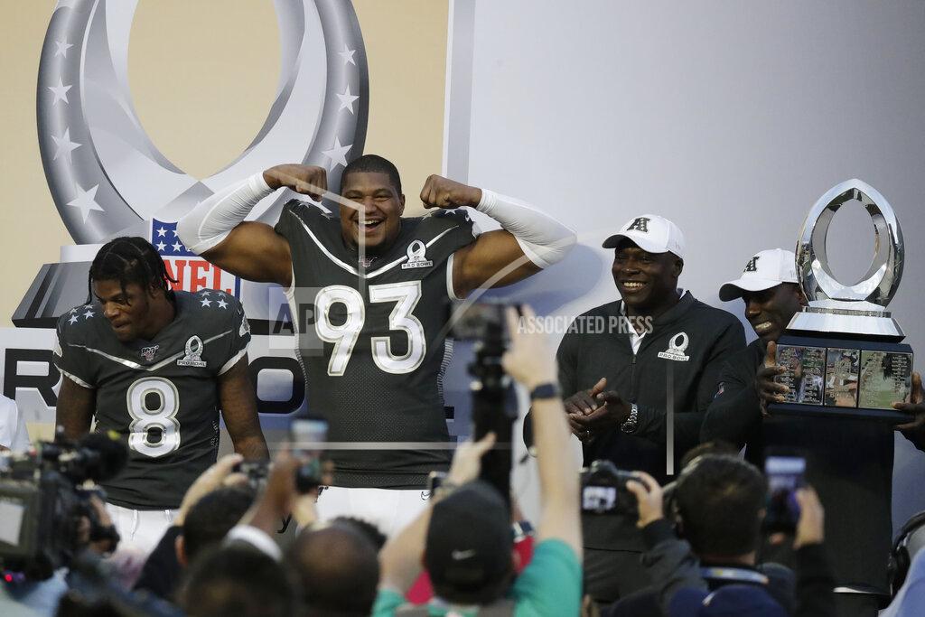 AFC defensive end Calais Campbell, of the Jacksonville Jaguars, (93) and quarterback Lamar Jackson, of the Baltimore Ravens, celebrate at the end of the NFL Pro Bowl football game against the NFC, Sunday, Jan. 26, 2020, in Orlando, Fla. The AFC defeated the NFC 38-33.(AP Photo/John Raoux)