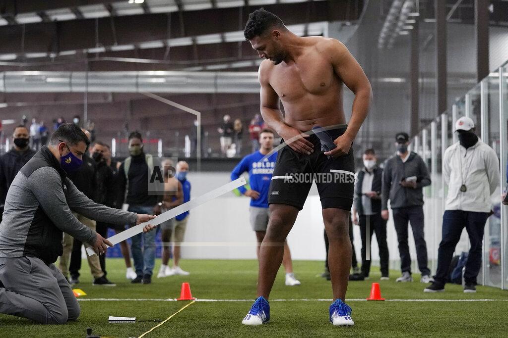 Sue Ogrocki Tulsa linebacker Zaven Collins looks back at the measurement of his broad jump at NFL football pro day Friday, April 2, 2021, in Tulsa, Okla. (AP Photo/Sue Ogrocki)