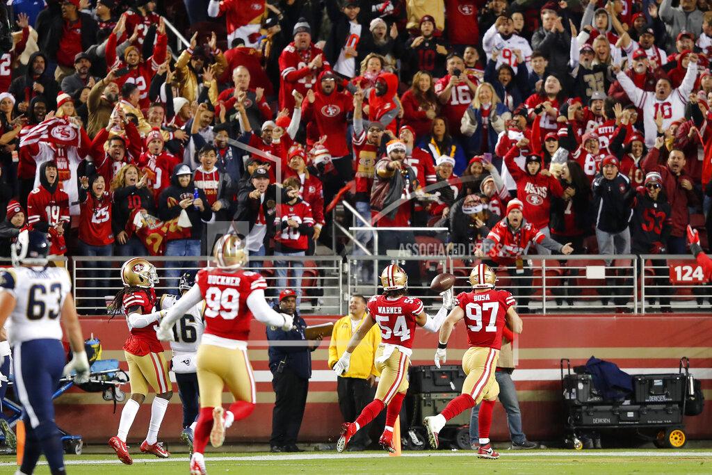 John Hefti Fans cheer as San Francisco 49ers middle linebacker Fred Warner (54) scores on an interception return against the Los Angeles Rams during the first half of an NFL football game in Santa Clara, Calif., Saturday, Dec. 21, 2019. (AP Photo/John Hefti)