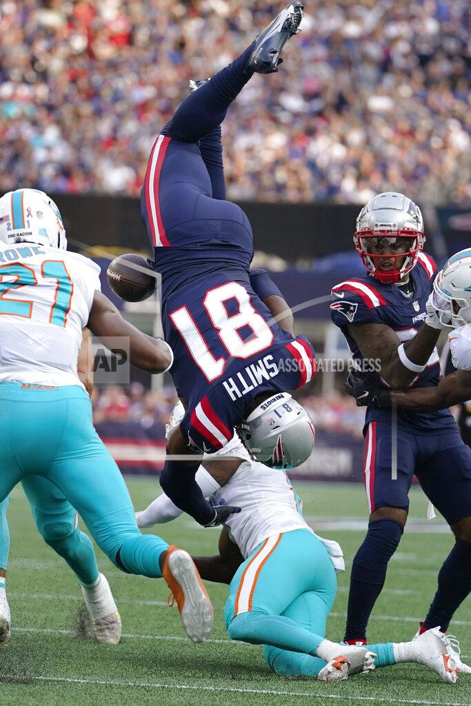 Steven Senne New England Patriots tight end Jonnu Smith (81) is upended by Miami Dolphins cornerback Justin Coleman during the first half of an NFL football game, Sunday, Sept. 12, 2021, in Foxborough, Mass. (AP Photo/Steven Senne)
