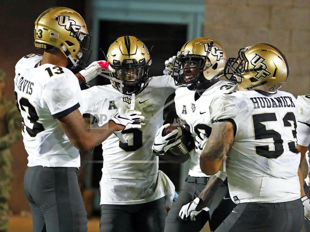 Karl B Deblaker Central Florida's Alex Swenson (30) is congratulated on his touchdown by teammates Dredrick Snelson (5), Bryon Brown (13) and Randy Shannon (53) during the second half of an NCAA college football game against East Carolina in Greenville, N.C., Saturday, Oct. 20, 2018. UCF won 37-10. (AP Photo/Karl B DeBlaker)