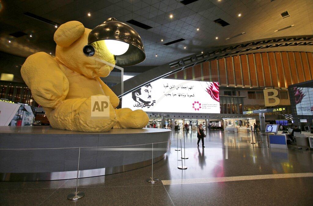 Kamran Jebreili FILE - A giant teddy bear adorns the Hamad International Airport in Doha, Qatar, May 6, 2018. Just as soccer fans going to a game in a European city might take a metro, tens of thousands of foreigners attending the World Cup in Qatar this month are commuting to matches by air. (AP Photo/Kamran Jebreili, File)