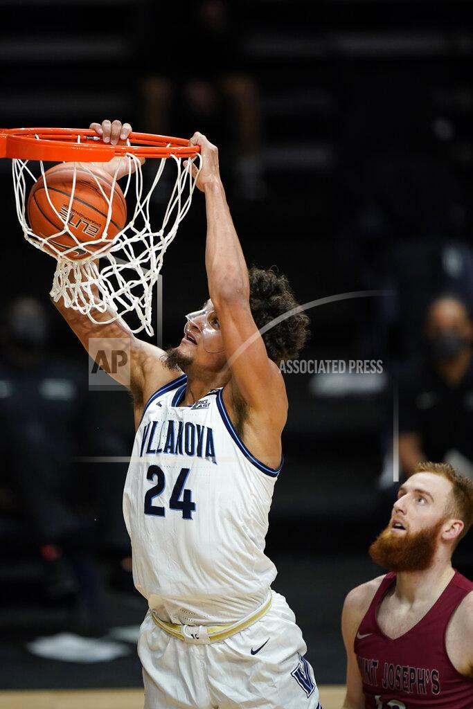 Matt Slocum Villanova's Jeremiah Robinson-Earl, left, goes up for a dunk past Saint Joseph's Anthony Longpre during the first half of an NCAA college basketball game, Saturday, Dec. 19, 2020, in Villanova, Pa. (AP Photo/Matt Slocum)