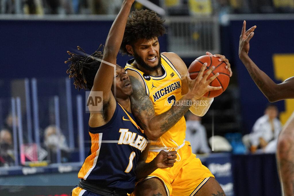 Paul Sancya Michigan forward Isaiah Livers (2) drives on Toledo guard Jamere Hill (1) in the second half of an NCAA college basketball game in Ann Arbor, Mich., Wednesday, Dec. 9, 2020. (AP Photo/Paul Sancya)