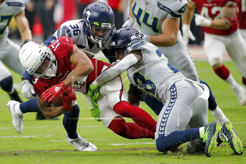 Rick Scuteri Arizona Cardinals wide receiver Christian Kirk (13) is tackled by Seattle Seahawks cornerback Akeem King (36) and cornerback Ugo Amadi (28) during the second half of an NFL football game, Sunday, Sept. 29, 2019, in Glendale, Ariz. (AP Photo/Rick Scuteri)