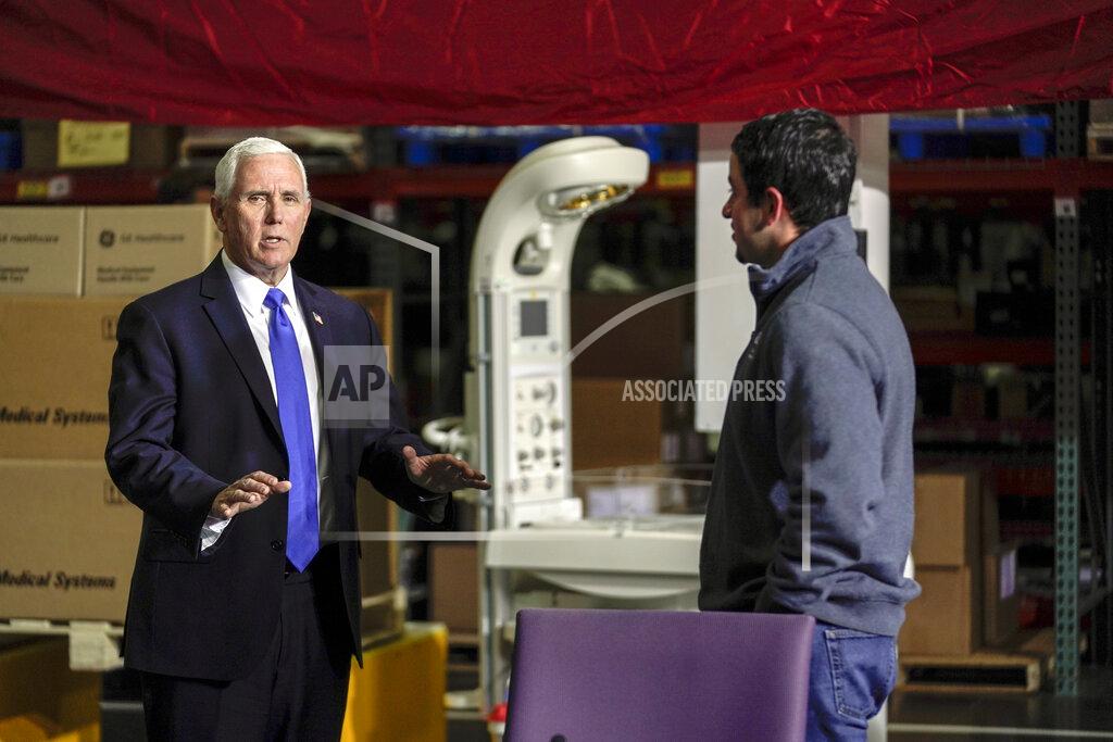 Morry Gash Vice President Mike Pence talks to Jose Castillo at the GE Healthcare manufacturing facility Tuesday April 21, 2020, in Madison, Wis. (AP Photo/Morry Gash)