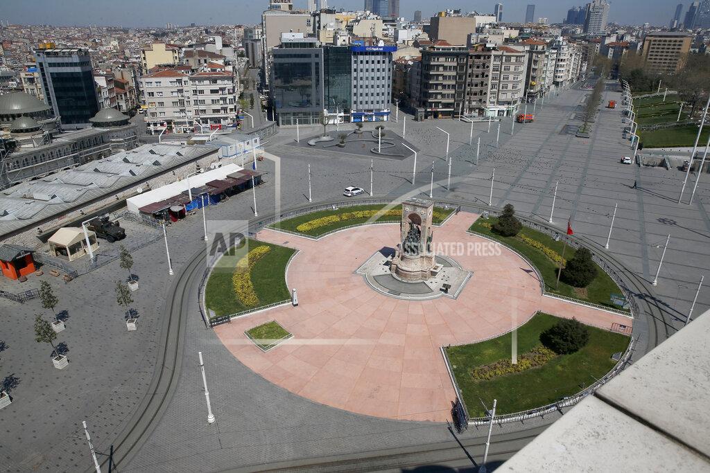 Mehmet Guzel A deserted Taksim Square, one of the city's landmarks, in Istanbul, Saturday, April 18, 2020, hours after the start of a two-day curfew declared by the government in an attempt to control the spread of coronavirus. (AP Photo/Mehmet Guzel)