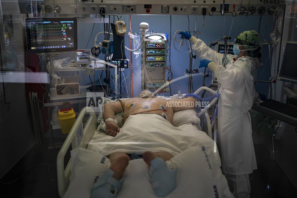 Felipe Dana A COVID-19 patient receives treatment in the ICU of the Hospital del Mar, in Barcelona, Spain, Tuesday, Jan. 19, 2021. The unrelenting increase in COVID-19 infections in Spain following the holiday season is again straining hospitals, threatening the mental health of doctors and nurses who have been at the forefront of the pandemic for nearly a year. (AP Photo/Felipe Dana)